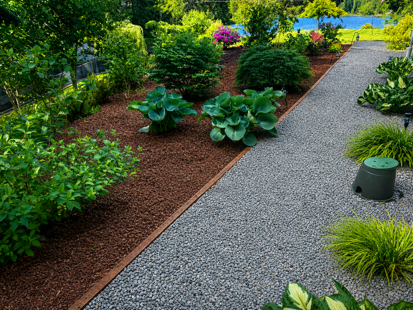 Finished gravel walkway beside landscaped planting beds